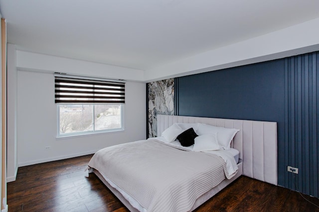 bedroom featuring dark wood finished floors and baseboards