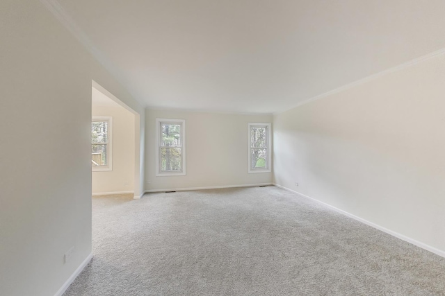 spare room featuring carpet floors and baseboards