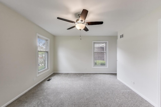 empty room with baseboards, carpet flooring, and visible vents