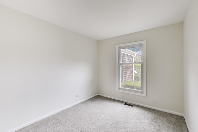 carpeted empty room with baseboards and visible vents