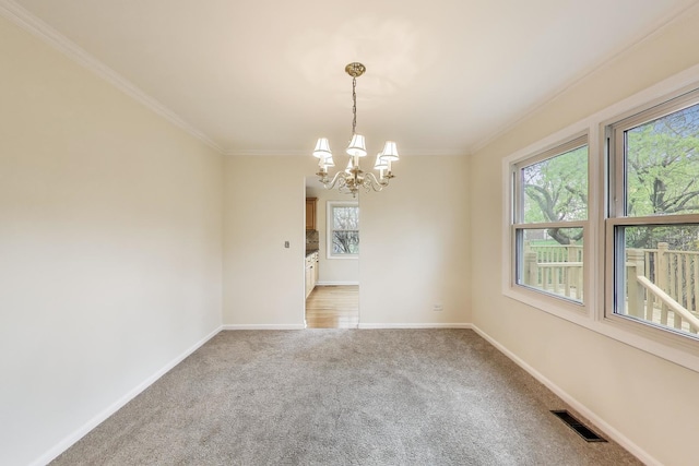 unfurnished room with a notable chandelier, visible vents, ornamental molding, and a healthy amount of sunlight