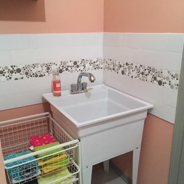 bathroom with tile walls and vanity