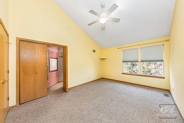 unfurnished bedroom with high vaulted ceiling, baseboards, visible vents, and carpet flooring