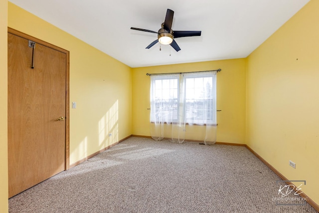 unfurnished room featuring ceiling fan, baseboards, and light colored carpet