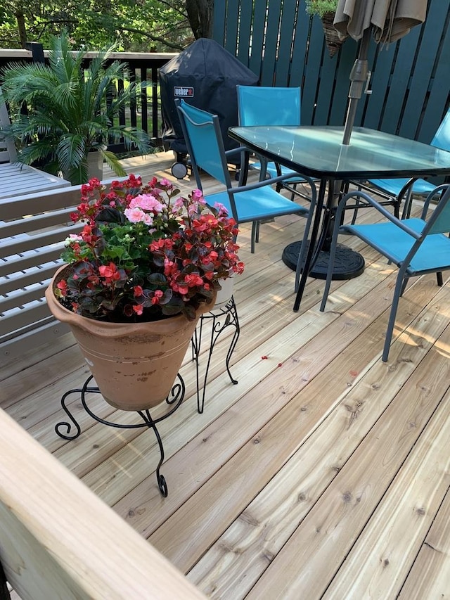 wooden terrace featuring outdoor dining space