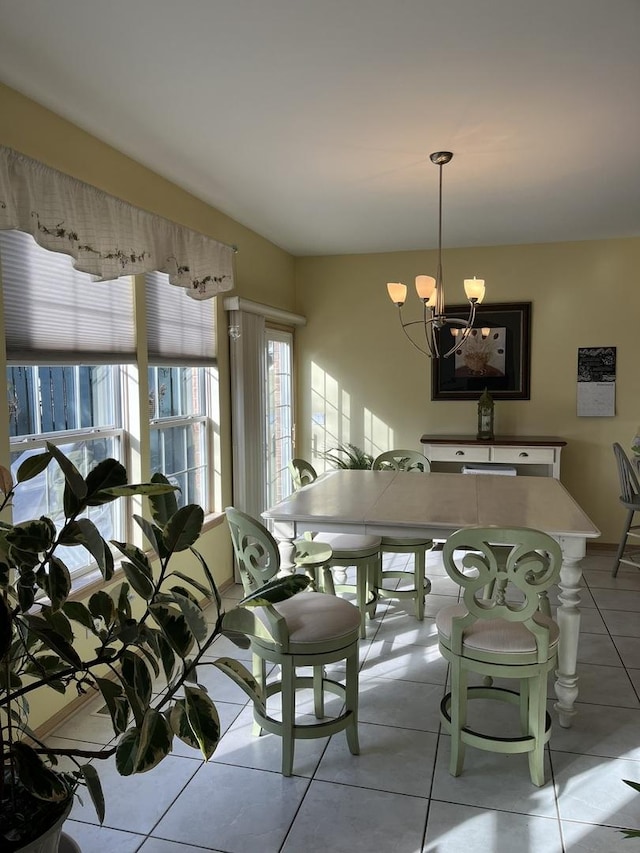 tiled dining space featuring a notable chandelier