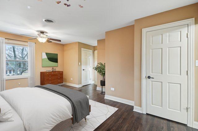 bedroom with baseboards, visible vents, ceiling fan, and dark wood-style flooring