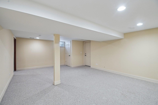 finished basement featuring recessed lighting, light colored carpet, and baseboards