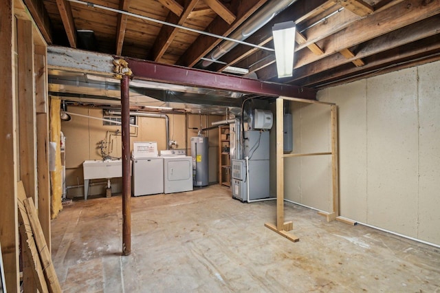 unfinished below grade area featuring heating unit, washing machine and clothes dryer, water heater, a sink, and electric panel