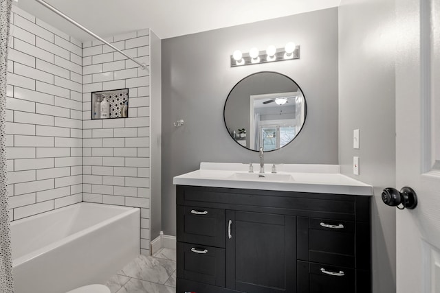 full bath with shower / bath combination, marble finish floor, and vanity