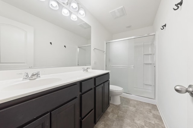 full bathroom with toilet, a stall shower, double vanity, and a sink