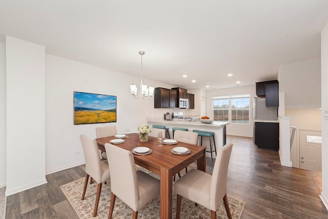 dining space with baseboards, a chandelier, dark wood finished floors, and recessed lighting