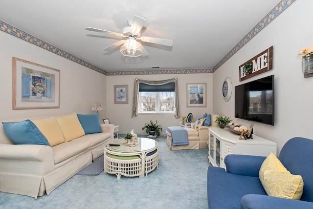 living room with ceiling fan and carpet flooring