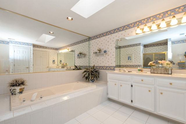 bathroom featuring a skylight, wallpapered walls, vanity, a bath, and tile patterned floors