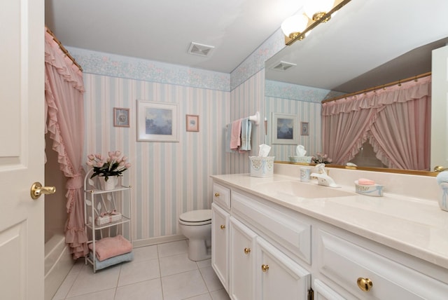 bathroom featuring visible vents, toilet, vanity, tile patterned flooring, and wallpapered walls