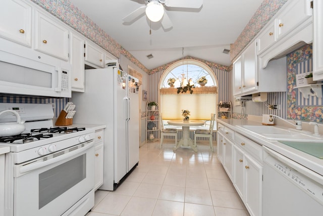 kitchen with white appliances, light countertops, and wallpapered walls