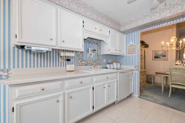 kitchen with wallpapered walls, white cabinetry, light countertops, and dishwasher