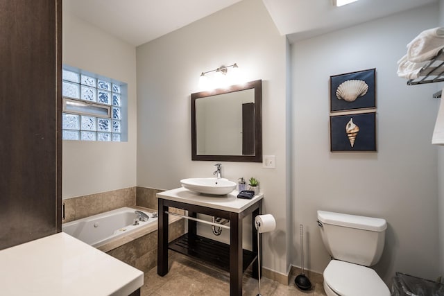 bathroom featuring a bath, toilet, and vanity