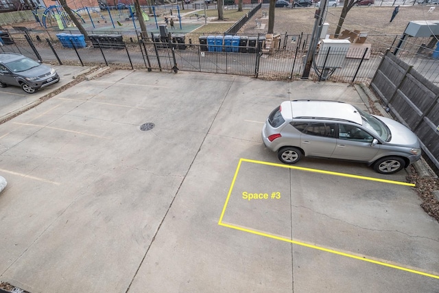 uncovered parking lot with a gate and fence