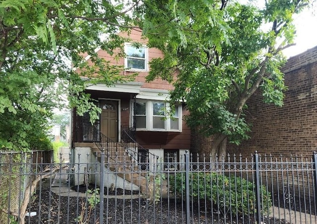 view of front of home with brick siding and a fenced front yard