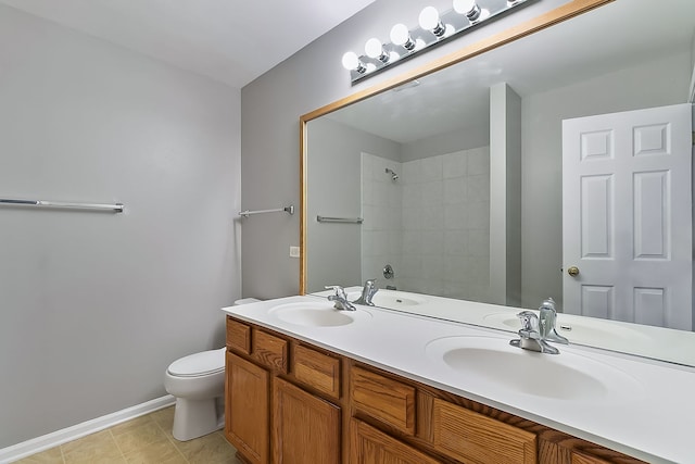 full bath with a shower, a sink, toilet, and double vanity