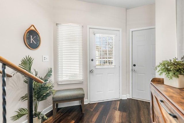 entryway featuring baseboards and dark wood finished floors