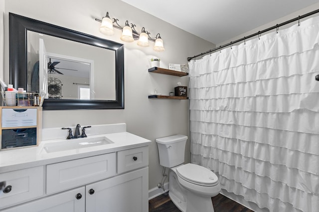 bathroom with vanity, wood finished floors, ceiling fan, curtained shower, and toilet