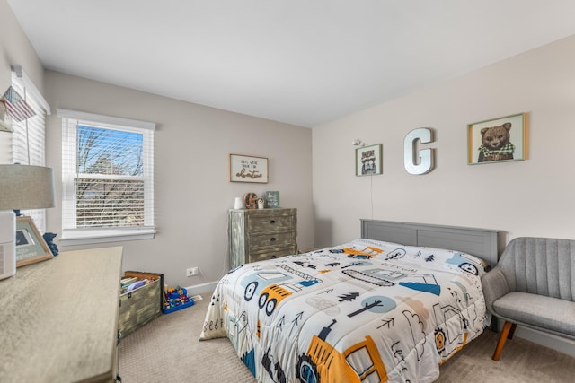 carpeted bedroom featuring baseboards