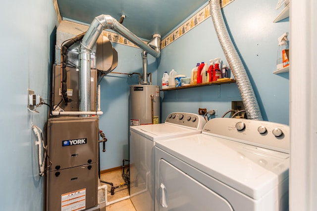 clothes washing area featuring independent washer and dryer, water heater, and laundry area