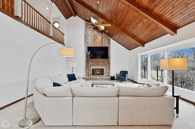 living area with beamed ceiling, a fireplace, carpet floors, and high vaulted ceiling