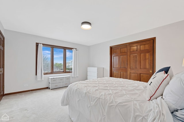 carpeted bedroom featuring baseboards