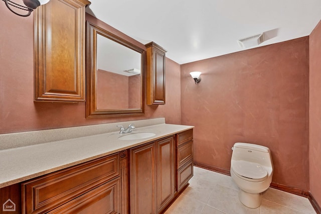 half bathroom with vanity, baseboards, visible vents, tile patterned floors, and toilet