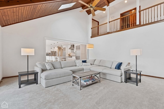 living area with carpet flooring, wood ceiling, and baseboards