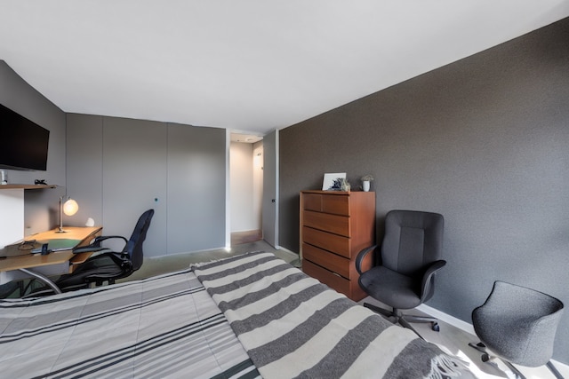 bedroom with a closet and baseboards