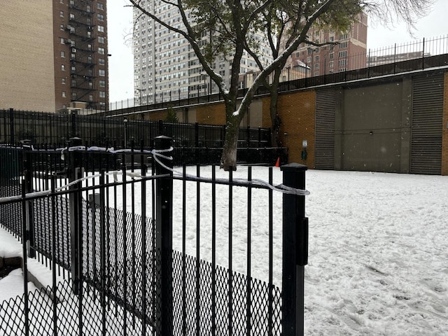 snow covered gate featuring fence