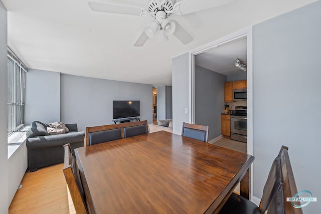 dining space featuring a ceiling fan and light wood-style floors