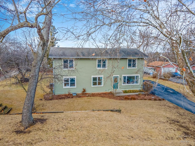 back of house featuring driveway