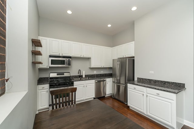 kitchen featuring stainless steel appliances, recessed lighting, white cabinetry, and dark wood-style floors