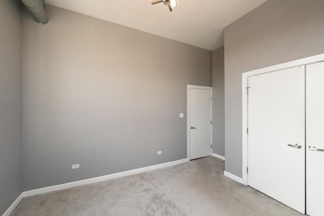 unfurnished bedroom with light carpet and baseboards