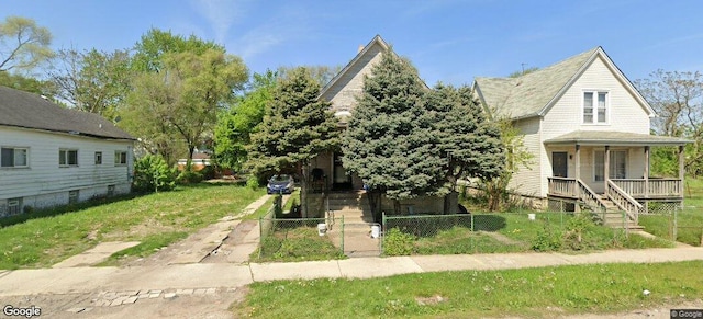 view of front of home featuring a fenced front yard, stairs, and a porch