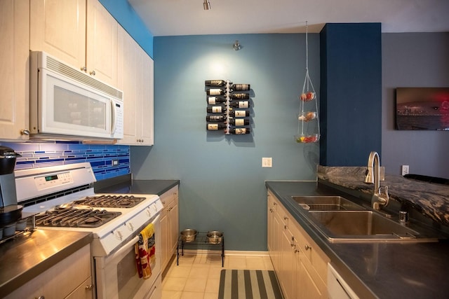 330 N Jefferson St Unit 603, Chicago, IL 60661 - kitchen featuring white appliances, decorative backsplash, light tile patterned floors, and dark countertops
