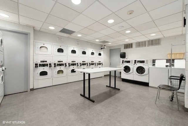 common laundry area featuring visible vents, independent washer and dryer, stacked washing maching and dryer, and tile patterned floors