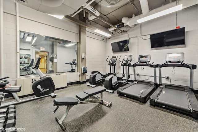 gym featuring concrete block wall