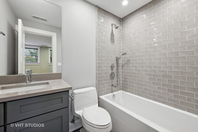 full bathroom featuring visible vents, vanity, toilet, and shower / tub combination