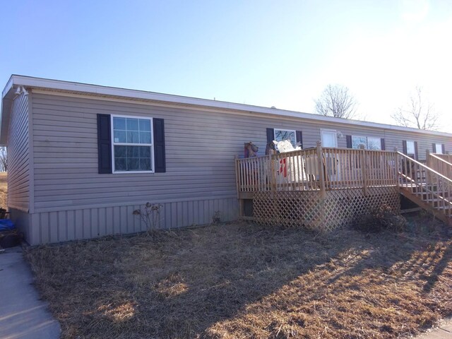 back of house with a deck