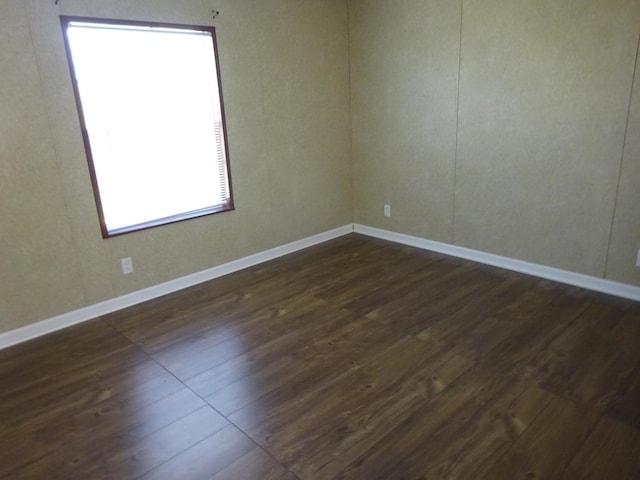 10615 N Coon Rd, Dakota, IL 61018 - unfurnished room featuring dark wood-style floors and baseboards