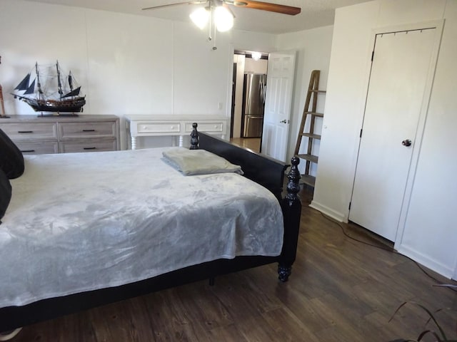 bedroom featuring a ceiling fan, wood finished floors, and freestanding refrigerator