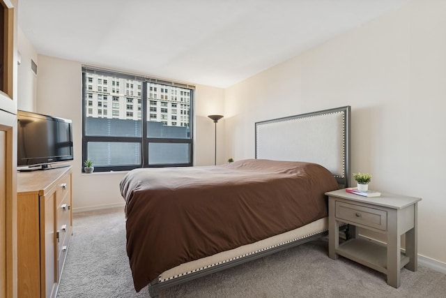 bedroom featuring baseboards, carpet floors, and visible vents