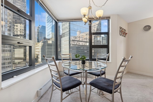 carpeted dining space with a view of city, baseboards, and a chandelier