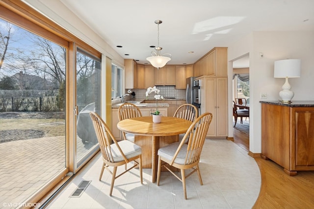 dining room with visible vents and light tile patterned floors